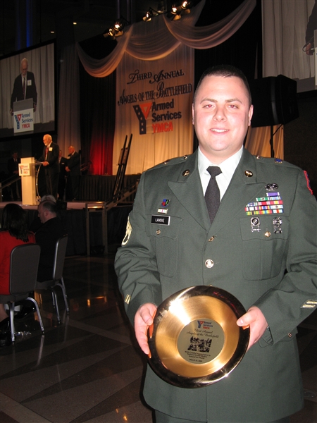 Army Staff Sgt. Matthew, a decorated army medic who served a tour in Iraq with the Rhode Island Army National Guard, poses with an award he accepted at the 3rd annual Armed Services YMCA 'Angels of Battlefield' gala in Washington, D.C., on March 11, 2009. DoD photo by John Kruzel  