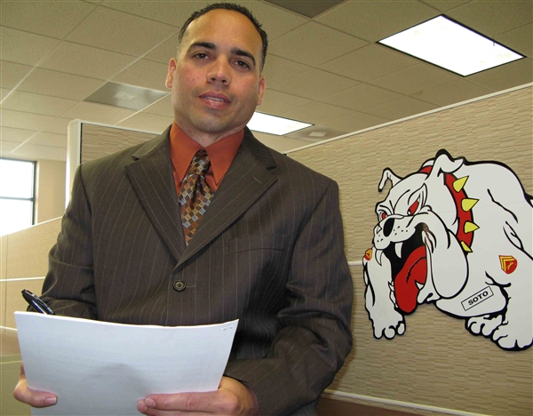 Alfredo Soto stands next to his depiction of a growling bulldog, the Marine Corps� mascot, in his work cubicle at the Marine Wounded Warrior Call Center in Dumfries, Va., Sept. 30, 2008. Defense Dept. photo by Gerry J. Gilmore 