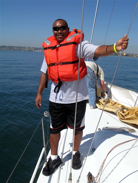 Marine Cpl. Sherman Watson, a Marine who suffered a traumatic brain injury in Iraq, savors a sail aboard a 43-foot racing sailboat during the National Veterans Summer Sports Clinic. DoD photo by Donna Miles  
